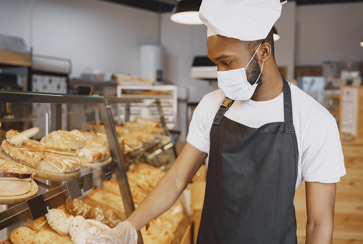 baker-uniform-giving-advice-about-pastry-man-wearing-protective-mask-buying-fresh-bread